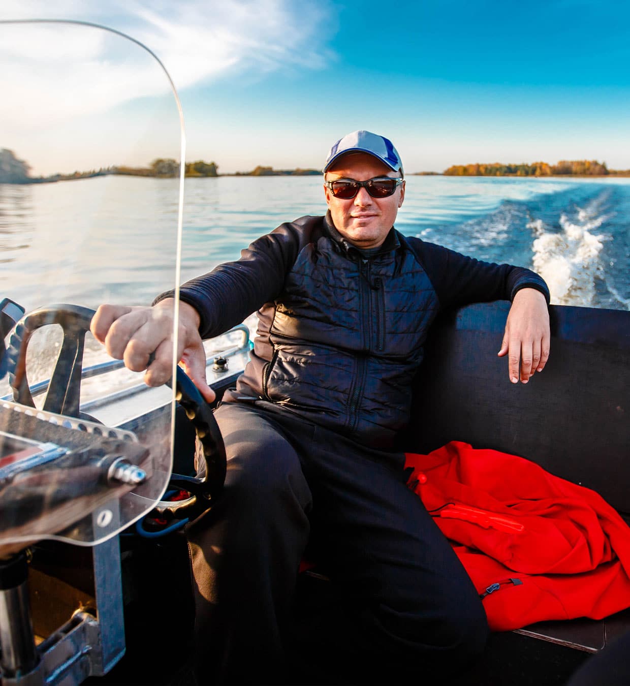 a person sitting in a boat on a body of water